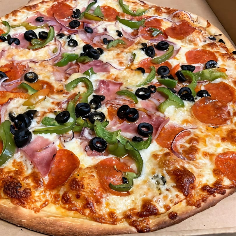 Di Angelo Pizza's large pizza with pepperoni, ham, green peppers, black olives, and red onions.