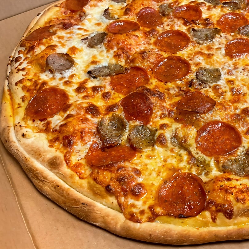 Di Angelo Pizza's pepperoni and sausage pizza with melted cheese and a golden crust.
